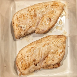 Place the chicken breasts into a baking dish