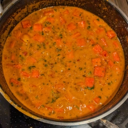 Gently heating the curry sauce with the watermelon cubes