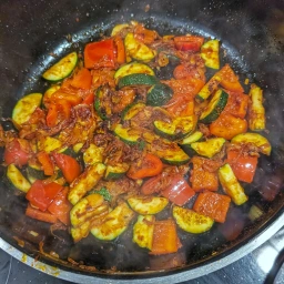 Onion, garlic, tomato paste, bell pepper and zucchini
