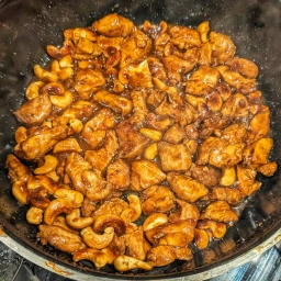 Marinated chicken breast fillet pieces with cashew nuts and thickened sauce