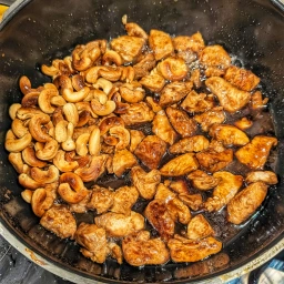 Marinated chicken breast fillet pieces with cashew nuts and sauce