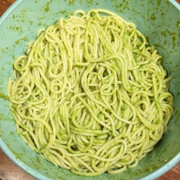 Mixing the spaghetti with the Pesto alla Genovese
