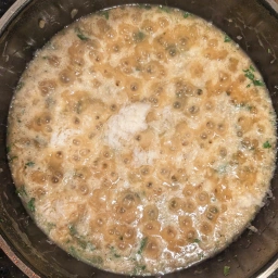 Adding the Grana Padano to the risotto