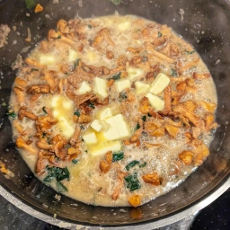 Sauce with butter pieces being incorporated