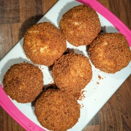 Marillenknödel rolled in breadcrumbs