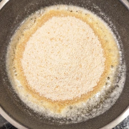 Adding breadcrumbs to the butter