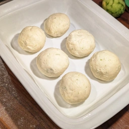Marillenknödel arranged in a dish for refrigeration